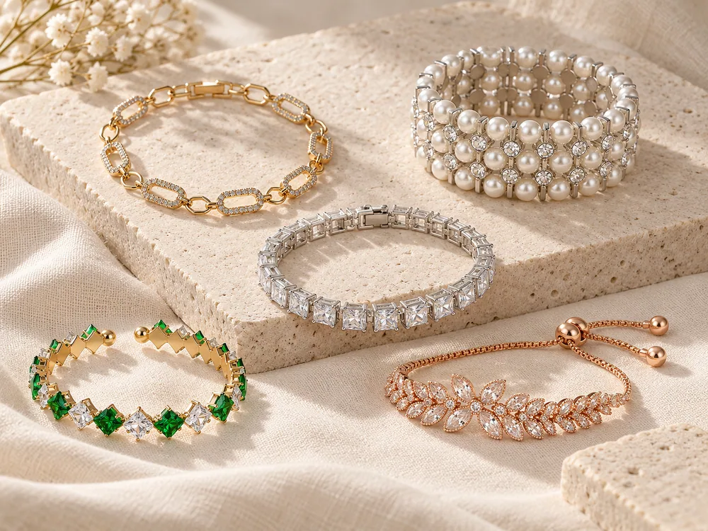 Editorial arrangement of chain, pearl, crystal tennis, open bangle and floral slider bracelet styles
